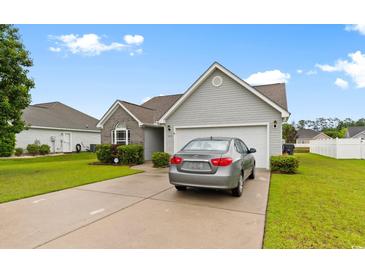 Charming single-Gathering home with a two-car garage, landscaped yard, and a private driveway at 696 Rambler Ct., Myrtle Beach, SC 29588