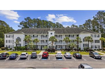 Spacious three-story condominium with palm trees and well-maintained landscaping with ample parking for residents and guests at 760 Charter Dr. # D-4, Longs, SC 29568