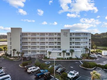 Beautiful exterior view of Sands Beach Club, featuring ample parking and meticulous landscaping at 9400 Shore Dr. # 509, Myrtle Beach, SC 29572