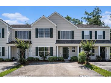 Charming townhome with well-maintained landscaping and neutral siding under a bright blue sky at 1196 Harvester Circle # 1196, Myrtle Beach, SC 29579