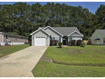 Charming one-story home with a well-manicured lawn, attached garage, and mature landscaping at 3805 Mayfield Dr., Conway, SC 29526