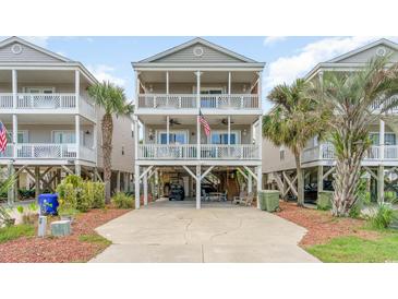 Charming three-story beach house with multiple decks and classic coastal architecture details at 712A Ocean Blvd. S, Surfside Beach, SC 29575