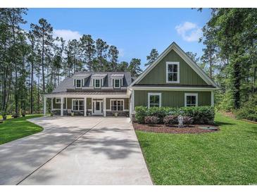 Inviting home featuring a manicured lawn, covered porch, and a concrete driveway at 109 Obd Way, Myrtle Beach, SC 29588