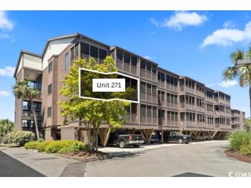 Three-story condo exterior with covered parking and screened in porches at 206 2Nd Ave. N # 271, North Myrtle Beach, SC 29582