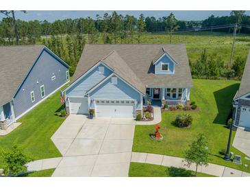 Charming home with a well-manicured lawn, inviting front porch, and a two-car garage at 2492 Goldfinch Dr., Myrtle Beach, SC 29577