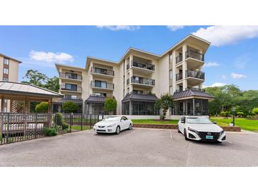 Beautiful condo building featuring multiple balconies and covered parking spaces in a coastal community at 307 74Th Ave. N # 3C, Myrtle Beach, SC 29572