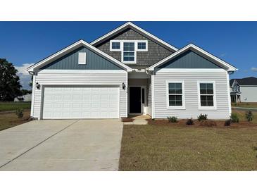 Charming single-Gathering home with a two-car garage, light siding, and beautiful architectural detail at 319 Garden Grove St, Conway, SC 29526