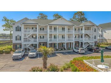 Three story condo with multiple balconies overlooking parking lot and distant waterway views at 4450 Turtle Ln. # 2-A, Little River, SC 29566
