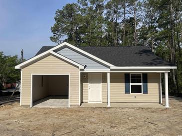 Charming single-story home featuring an attached garage and a cozy front porch at 5408 Hampton Rd., Conway, SC 29527