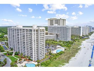 Expansive aerial view of beachfront condos with pools, lush landscaping, and stunning ocean views at 9820 Queensway Blvd. # 804, Myrtle Beach, SC 29572