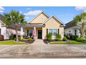 Charming yellow home featuring a well-manicured lawn and an inviting front porch at 1404 Riverport Dr., Conway, SC 29526