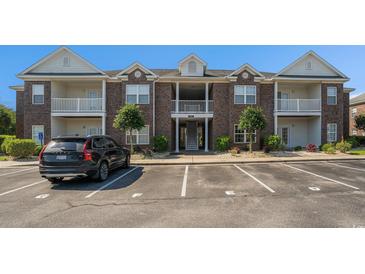 A charming brick condo building features upper and lower balconies in a landscaped community at 2029 Silvercrest Dr. # 22B, Myrtle Beach, SC 29579