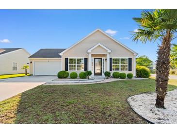 Charming single-story home featuring well-manicured landscaping and a welcoming entrance with black shutters at 2072 Haystack Way, Myrtle Beach, SC 29579