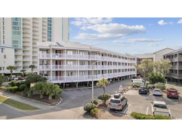 Coastal condo building with ample parking and white balconies near the beach at 210 N Ocean Blvd. # 333, North Myrtle Beach, SC 29582