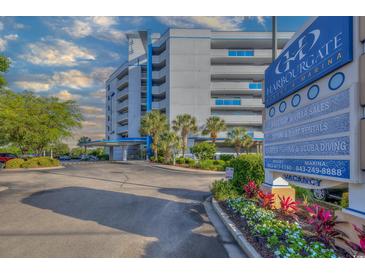HarbourGate Resort and Marina building exterior showing entrance, signage and landscaping on a partially cloudy day at 2100 Sea Mountain Hwy. # 202, North Myrtle Beach, SC 29582
