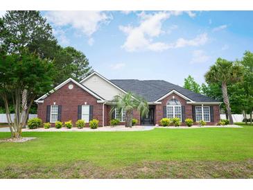 Inviting one-story brick home with a well-manicured lawn and mature landscaping at 249 Ashepoo Creek Dr., Myrtle Beach, SC 29579