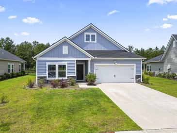 Charming single-story home with blue siding, well-manicured lawn, and a two-car attached garage at 3021 Sistine St., Myrtle Beach, SC 29579