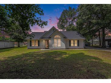 Charming single-story home featuring a well-manicured lawn and classic architectural details, creating a welcoming curb appeal at 3429 Mishoe St., Loris, SC 29569