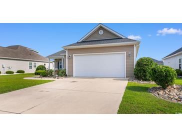 Single story home featuring a two car garage and manicured front yard with landscaping at 388 Hillsborough Dr., Conway, SC 29526