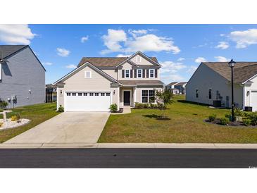 Charming two-story home featuring a two-car garage and well-manicured lawn in a Gathering-friendly community at 4410 Honir Dr., Myrtle Beach, SC 29579