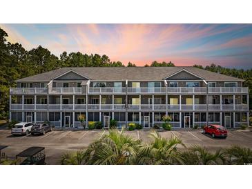 Attractive condo building featuring multi-level balconies, well-manicured landscaping, and convenient parking at 4506 West Harbor Ct. # U-15, Little River, SC 29566