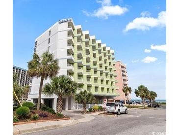 Modern condo building featuring a white exterior and multiple balconies in a vibrant beachside community at 7000 N Ocean Blvd. # 427, Myrtle Beach, SC 29572