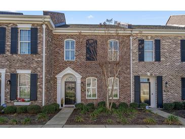 Charming brick townhome with black shutters, neat landscaping, and inviting front entrance at 750 Howard Ave. # C, Myrtle Beach, SC 29577