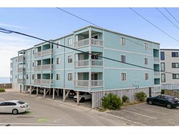 Three story condo building featuring light blue siding and white railings and trim at 824 N Waccamaw Dr. # 204, Murrells Inlet, SC 29576
