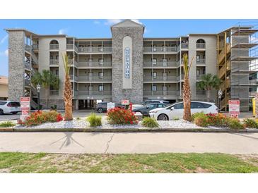 Surf Watch II condo building featuring multiple floors, balconies, landscaping, and parking at 917 S Ocean Blvd. # 103, Surfside Beach, SC 29575