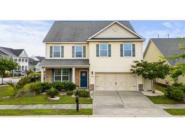 Charming two-story home with landscaped front yard, a two car garage and welcoming blue front door at 1189 Wyatt Ln., Myrtle Beach, SC 29577