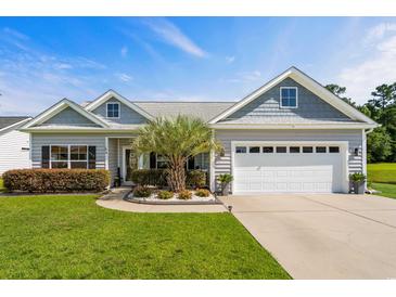 Charming single-story home with a well-manicured lawn, a two-car garage and nice landscaping at 142 Grier Crossing Dr., Conway, SC 29526
