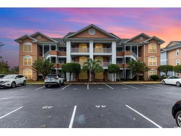 Condominium complex featuring architectural details and well-maintained landscaping at 4633 Lightkeepers Way # 5-F, Little River, SC 29566