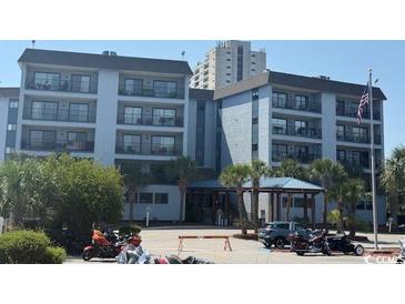 Building's attractive exterior with palm trees and an American flag waving in the breeze at 5905 S Kings Hwy. # 344B, Myrtle Beach, SC 29575