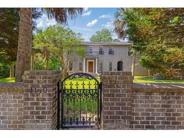 Charming two-story home with a brick facade and an ornate wrought iron gate at 1140 Waterway Ln., Myrtle Beach, SC 29572