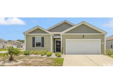 Charming single-story home features a well-manicured lawn, neutral siding, and an attached two-car garage at 1170 Maxwell Dr., Little River, SC 29566