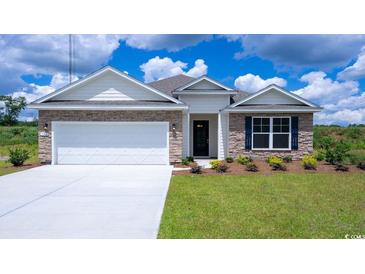 Charming single-story home with stone accents, a well-manicured lawn, and a two-car garage at 141 Stride Ct., Myrtle Beach, SC 29588