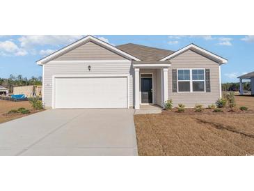 Charming single-story home featuring a gray facade, white garage door, and well-manicured lawn at 1411 Nokota Dr., Conway, SC 29526