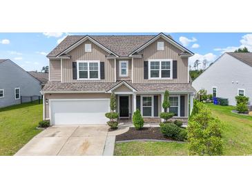Charming two-story home with neutral siding, black shutters, manicured landscaping, and an attached two-car garage at 148 Long Leaf Pine Dr., Conway, SC 29526
