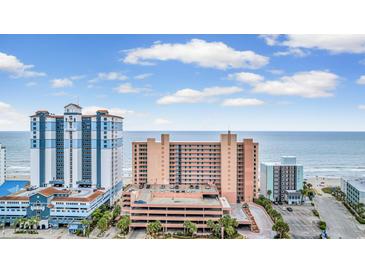Coastal condo complex featuring beautiful ocean views, multi-story parking, and manicured landscaping at 2207 S Ocean Blvd. # 1517, Myrtle Beach, SC 29577