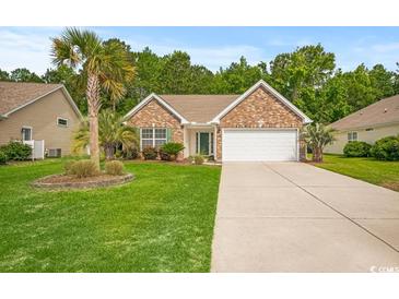 Charming brick home featuring a two-car garage, a well-manicured lawn, and mature landscaping at 231 Marbella Dr., Murrells Inlet, SC 29576