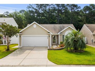 Charming single-story home featuring a well-manicured lawn and two-car garage at 2448 Whetstone Ln., Myrtle Beach, SC 29579