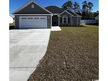 Charming single-story home with a gray exterior, manicured lawn, and attached two-car garage at 3530 Good Luck Rd., Aynor, SC 29511