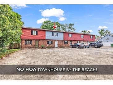 Townhouse exterior with brick and siding, showcasing its multi-Gathering design and ample parking space at 633 Sparrow Dr. # B, Surfside Beach, SC 29575