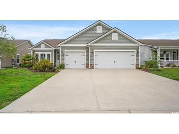 Charming home with a two-car garage, stone accents, and well-manicured lawn at 720 Little Fawn Way, Myrtle Beach, SC 29579