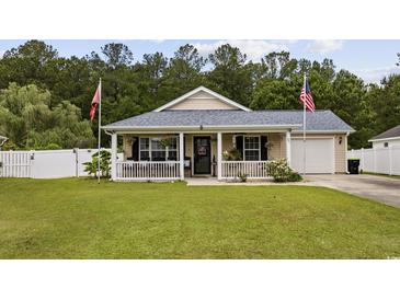 Charming single-story home with a well-manicured lawn, cozy front porch, and attached garage at 721 Dunlon Ct., Myrtle Beach, SC 29588