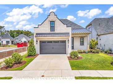Charming single Gathering home featuring a two-car garage and a well manicured lawn at 8469 Cape Dutch Loop, Myrtle Beach, SC 29572