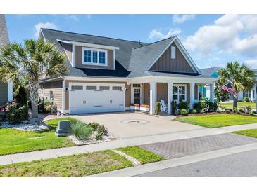 Charming home with a well-manicured lawn, two car garage, and covered front porch at 1145 Captain Hooks Way, North Myrtle Beach, SC 29582