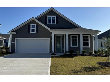 Charming single-Gathering home featuring a gray exterior, manicured lawn, and a two-car garage at 149 Stride Ct., Myrtle Beach, SC 29588