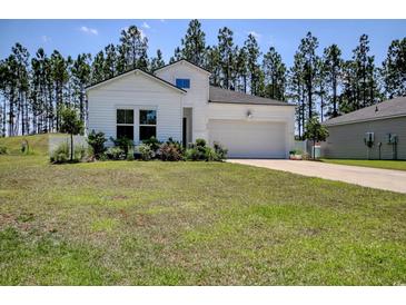 Charming single-story home with white siding, manicured lawn, and attached two-car garage at 212 Carolina Lakes Blvd., Myrtle Beach, SC 29588