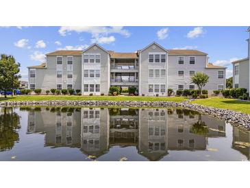 Beautiful exterior of this condominium community reflected in a well maintained lake at 2265 Huntingdon Dr. # J, Surfside Beach, SC 29575